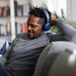 Person enjoying IPTV channels at home
